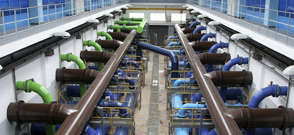 A large room with many pipes and water pumps.